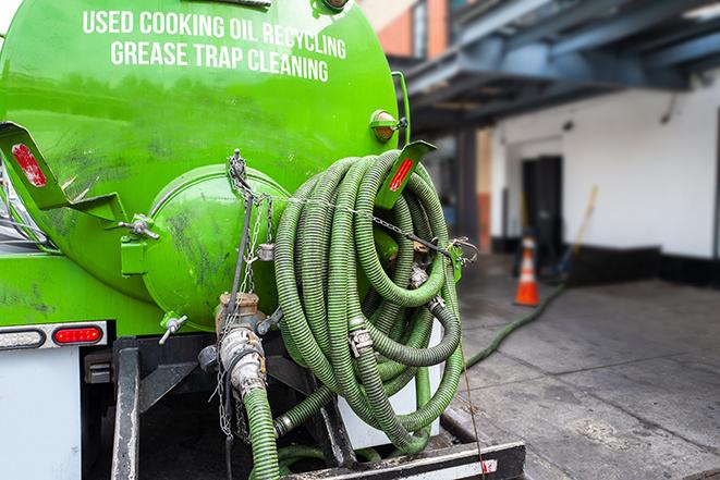 heavy-duty vacuum truck pumping out a grease trap in Bay City MI